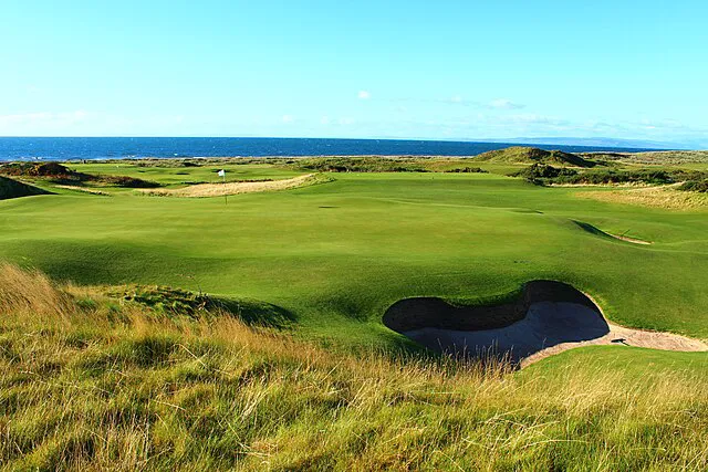 The Ailsa Course at Turnberry with the iconic lighthouse and Ailsa Craig visible across the Firth of Clyde