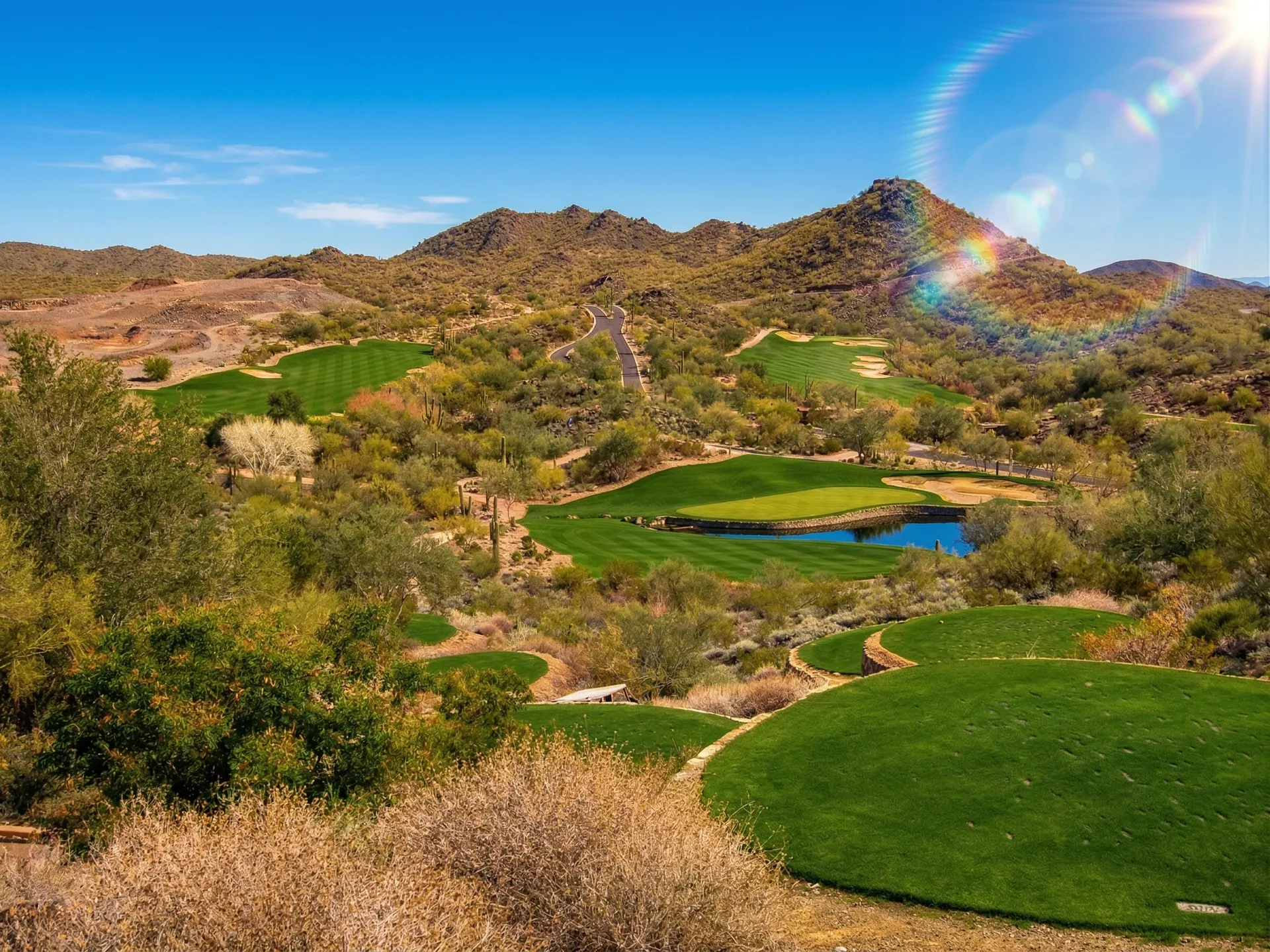Dramatic downhill par 3 at Quintero Golf Club with the Hieroglyphic Mountains and Sonoran Desert stretching beyond, Peoria, Arizona