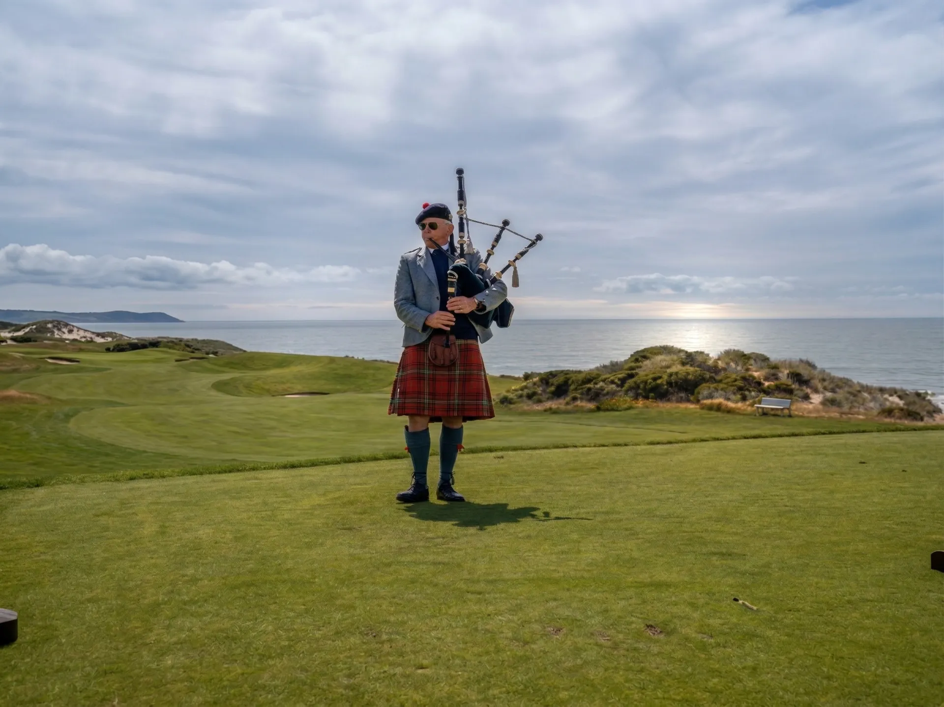 The Links at Spanish Bay stretching along the Pacific coastline with rolling dunes and Del Monte Forest in the background